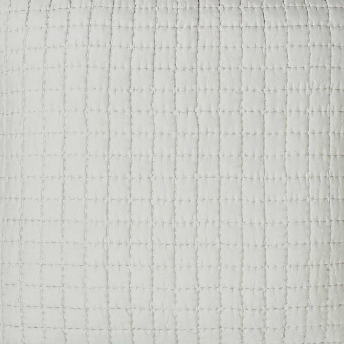 Close-up of the Malibu Mist silk pillow sham showing pale gray fabric, square pick-stitch quilting, and softly puckered texture.