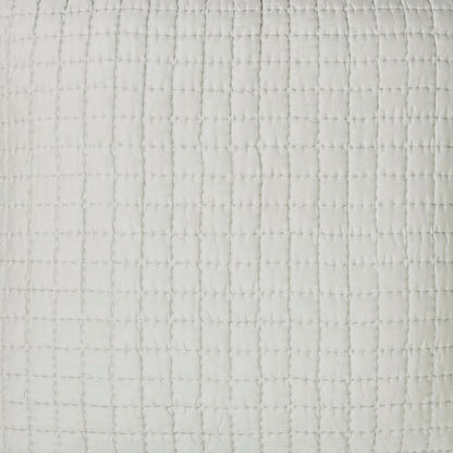 Close-up of the Malibu Mist silk pillow sham showing pale gray fabric, square pick-stitch quilting, and softly puckered texture.