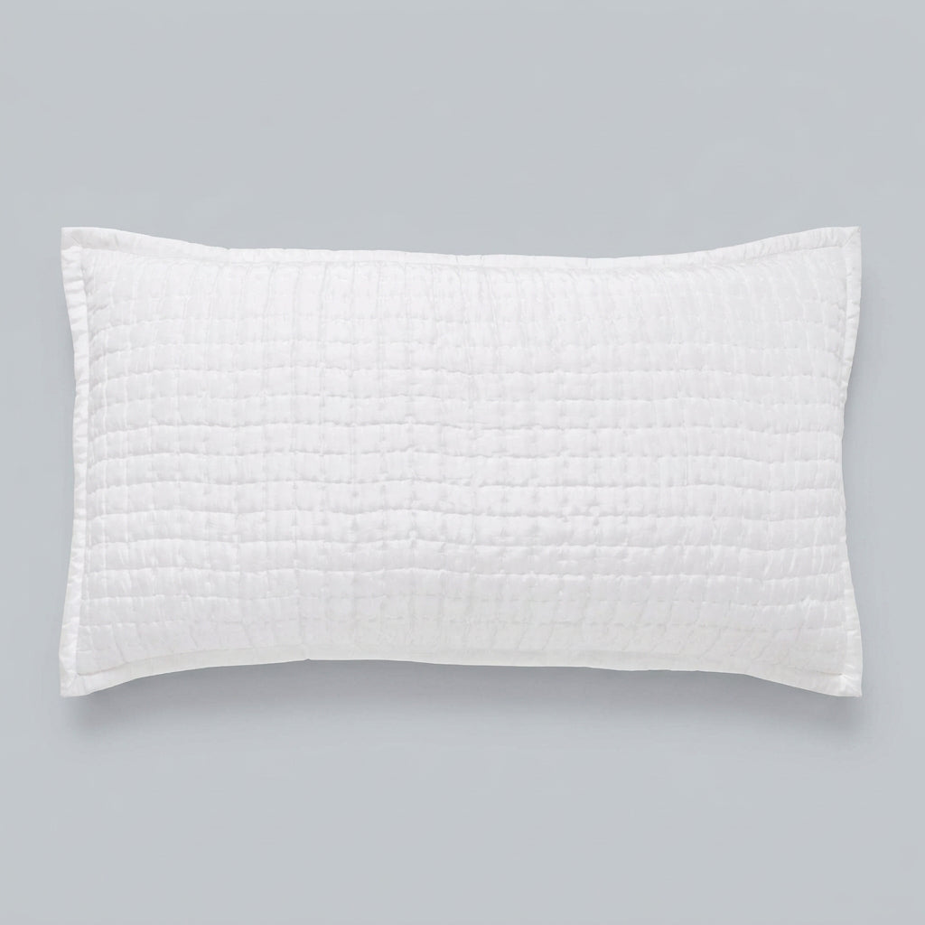 Front view of the Malibu Pearl rectangular silk pillow sham, showing its soft off-white tone, square pick-stitch quilting, and smooth border against a gray background.