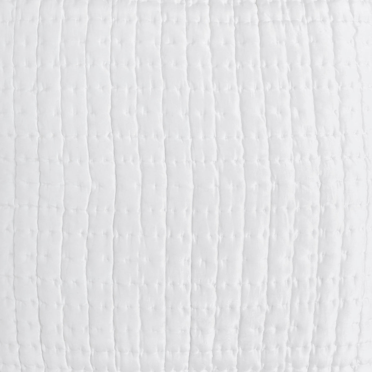 Close-up of the Malibu Pearl silk pillow sham showing soft off-white fabric and closely spaced square pick-stitch quilting.