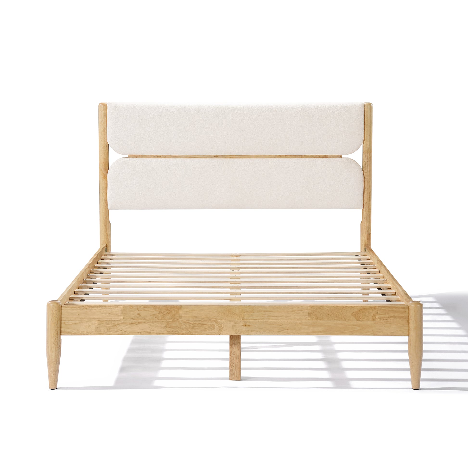 A side profile view of a Queen Platform Bed showcasing the integrated supportive slats, tapered legs, and the dual-panel ivory fleece headboard on a Durable Rubberwood Frame.