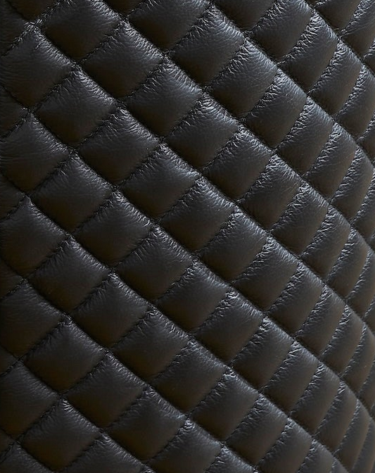 Quilted Round Leather Nightstand black genuine leather diamond quilting close detail texture