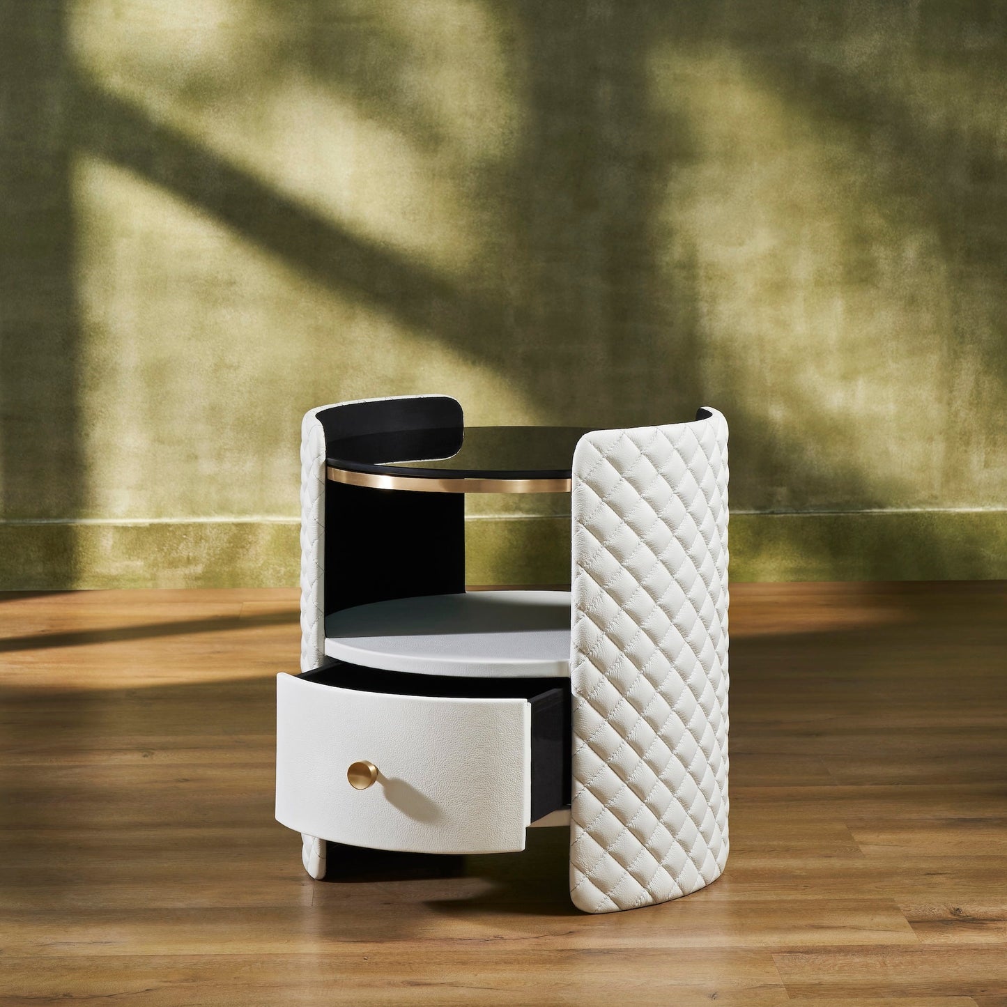 Quilted Round Leather Nightstand white angled view open drawer brass pull diamond quilting natural light