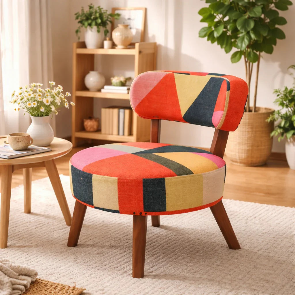 Rainbow Loom round accent chair with geometric cotton chenille upholstery styled in a warm living room with wood shelving and indoor plants

