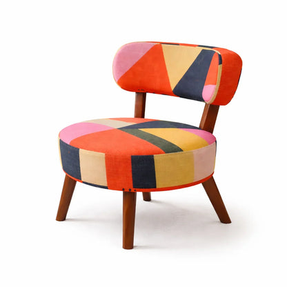 Rainbow Loom round accent chair with geometric cotton chenille print in orange, pink, yellow, and navy on mango wood legs

