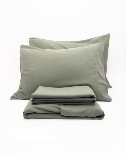 Signature Milk Fibre Core Set Highlands Green two pillowcases and folded sheets on a white background