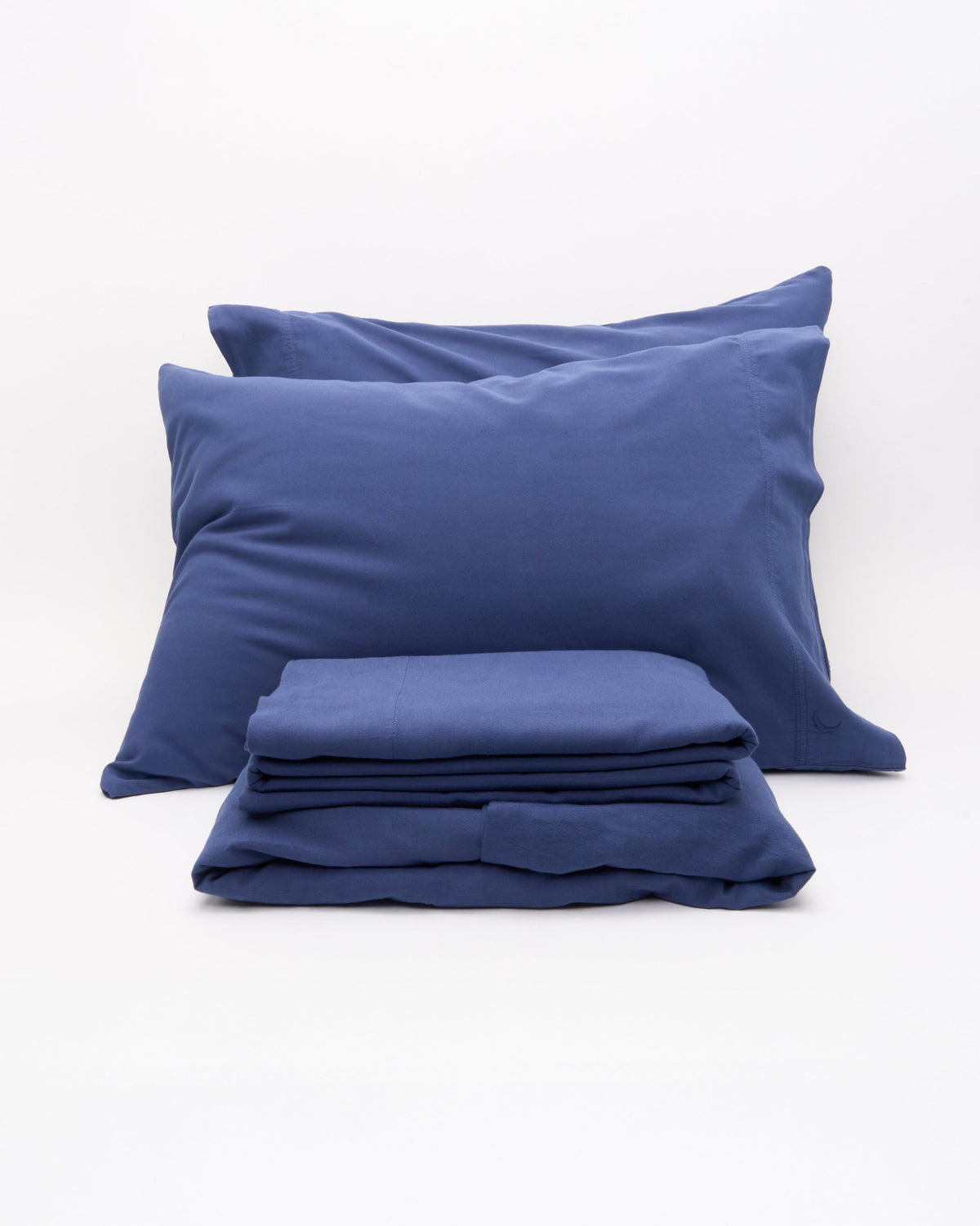 Signature Milk Fibre Deluxe Set Lunar Blue two pillowcases and folded sheets on a white background