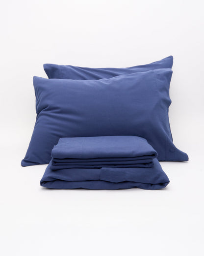 Signature Milk Fibre Deluxe Set Lunar Blue two pillowcases and folded sheets on a white background