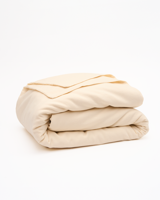 Signature Milk Fibre Duvet Cover Cream casein cotton duvet cover neatly folded on a white background