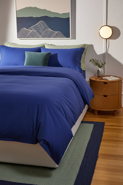 Signature Milk Fibre Duvet Cover Lunar Blue on a styled bed with modern bedroom setting and mountain landscape wall art