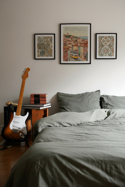 Signature Milk Fibre Sheet Set in Highlands Green styled on bed with Portugal travel art and guitar in cozy bedroom