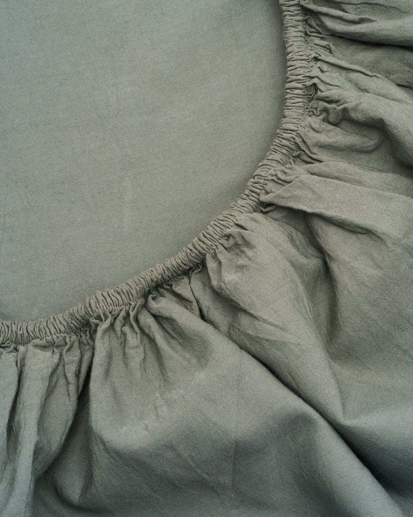 Signature Milk Fibre Sheet Set in Highlands Green fitted sheet elastic corner close up detail