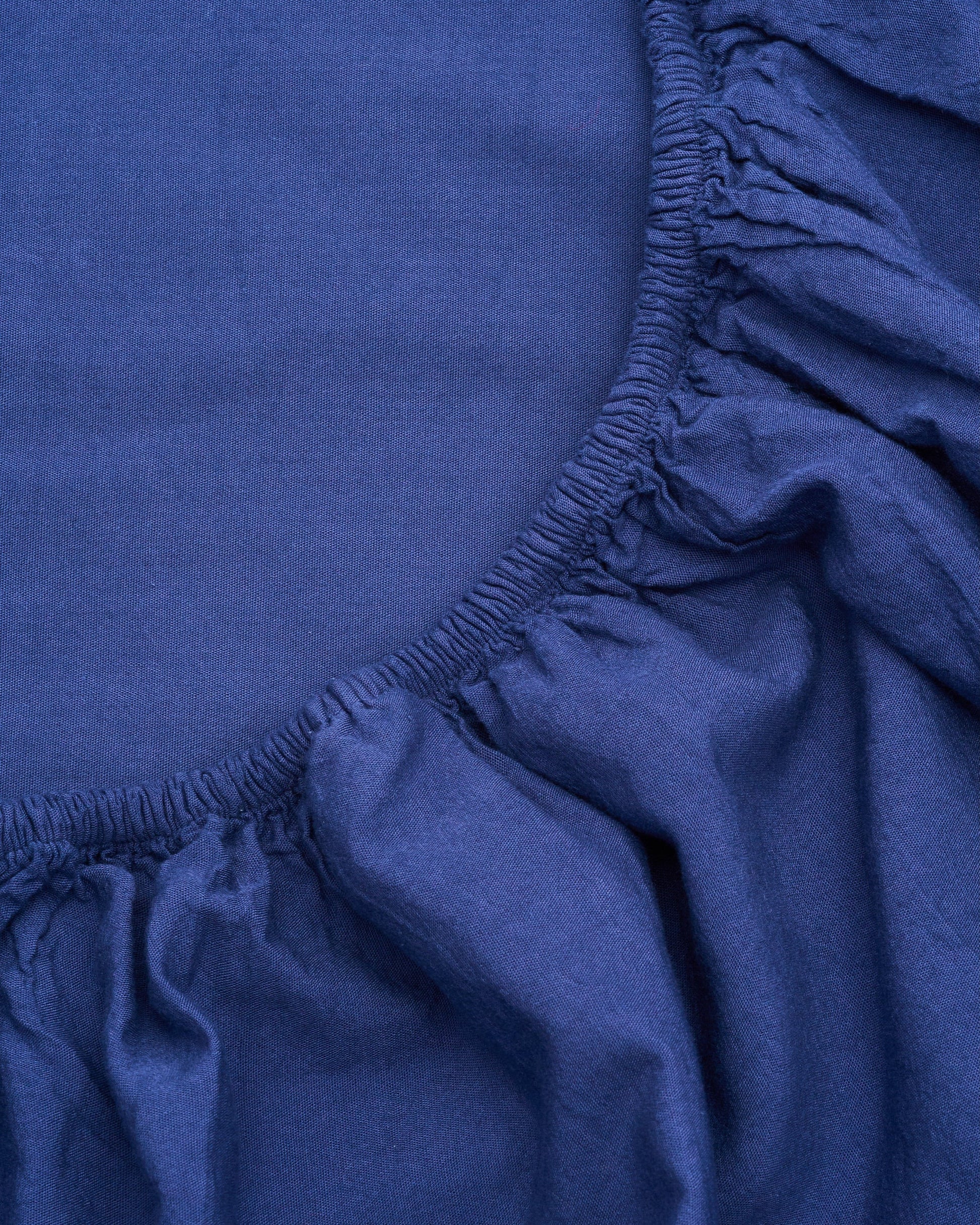Signature Milk Fibre Sheet Set in Lunar Blue fitted sheet elastic corner close up detail