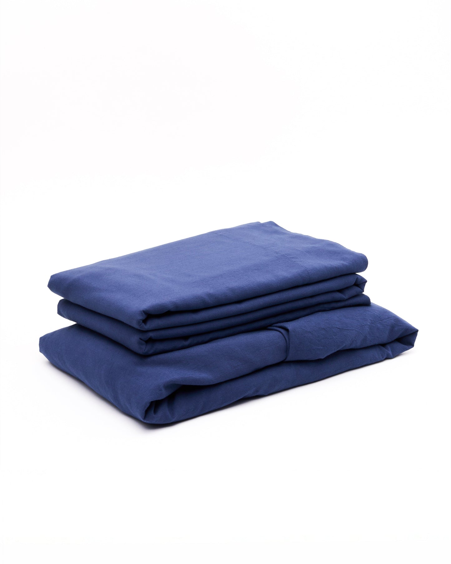 Signature Milk Fibre Sheet Set in Lunar Blue folded stack on white background