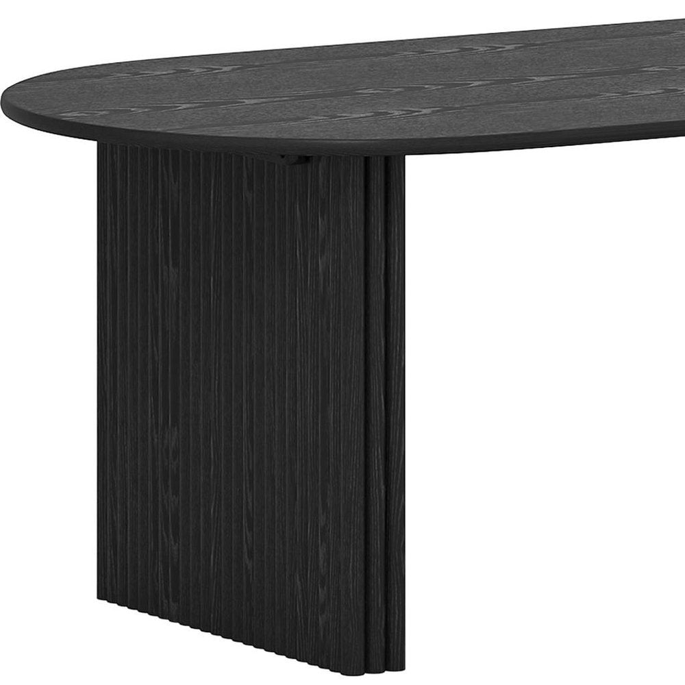 Close-up of oval tabletop edge and fluted pedestal base on solid wood double pedestal oval dining table in black finish showing oak grain and ribbed panel construction