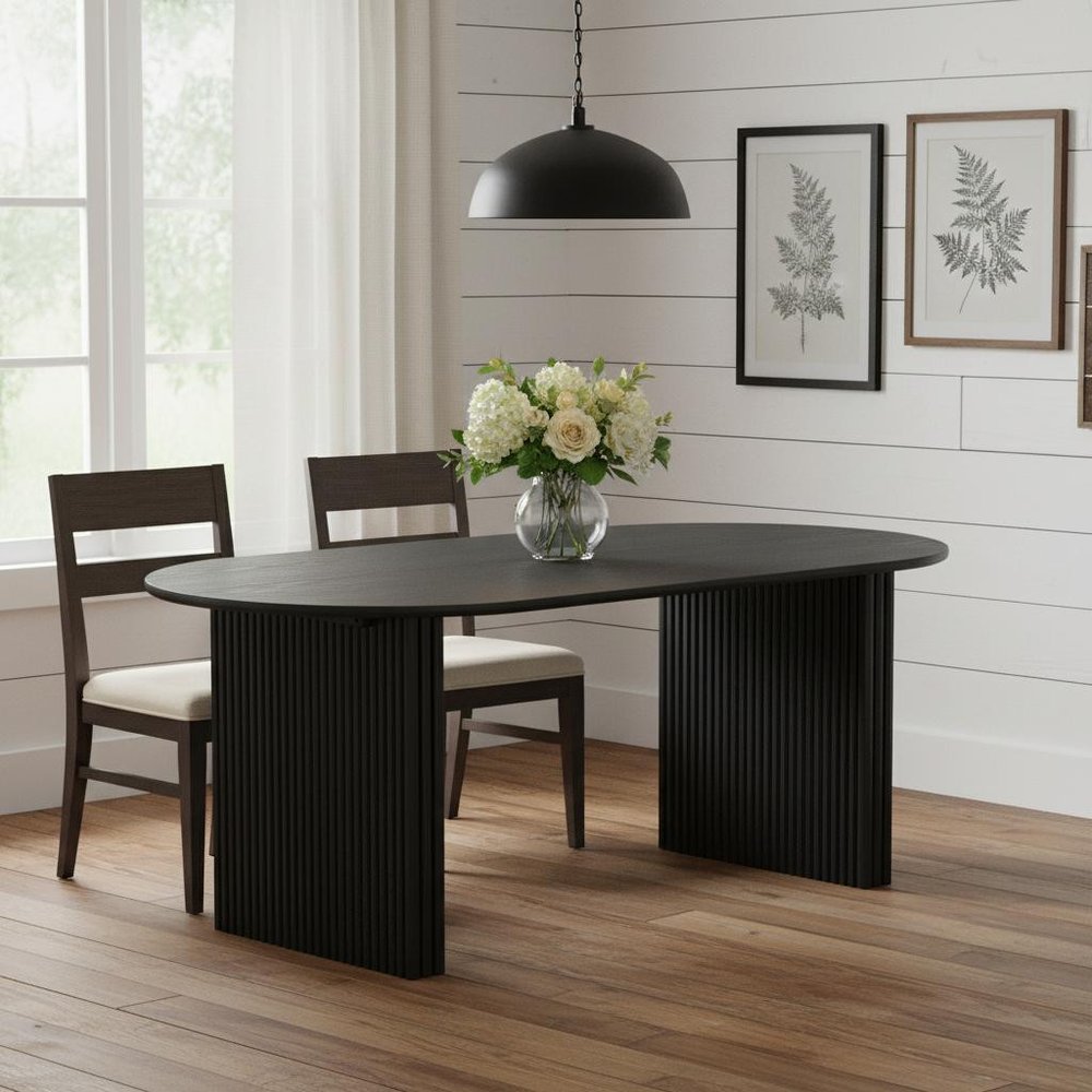 Solid wood double pedestal oval dining table in black finish with fluted base panels and oval top, styled in a modern farmhouse dining room