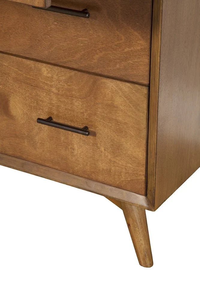 Lower corner detail of solid mahogany chest showing honey amber grain dark metal bar pull curved apron and splayed tapered leg