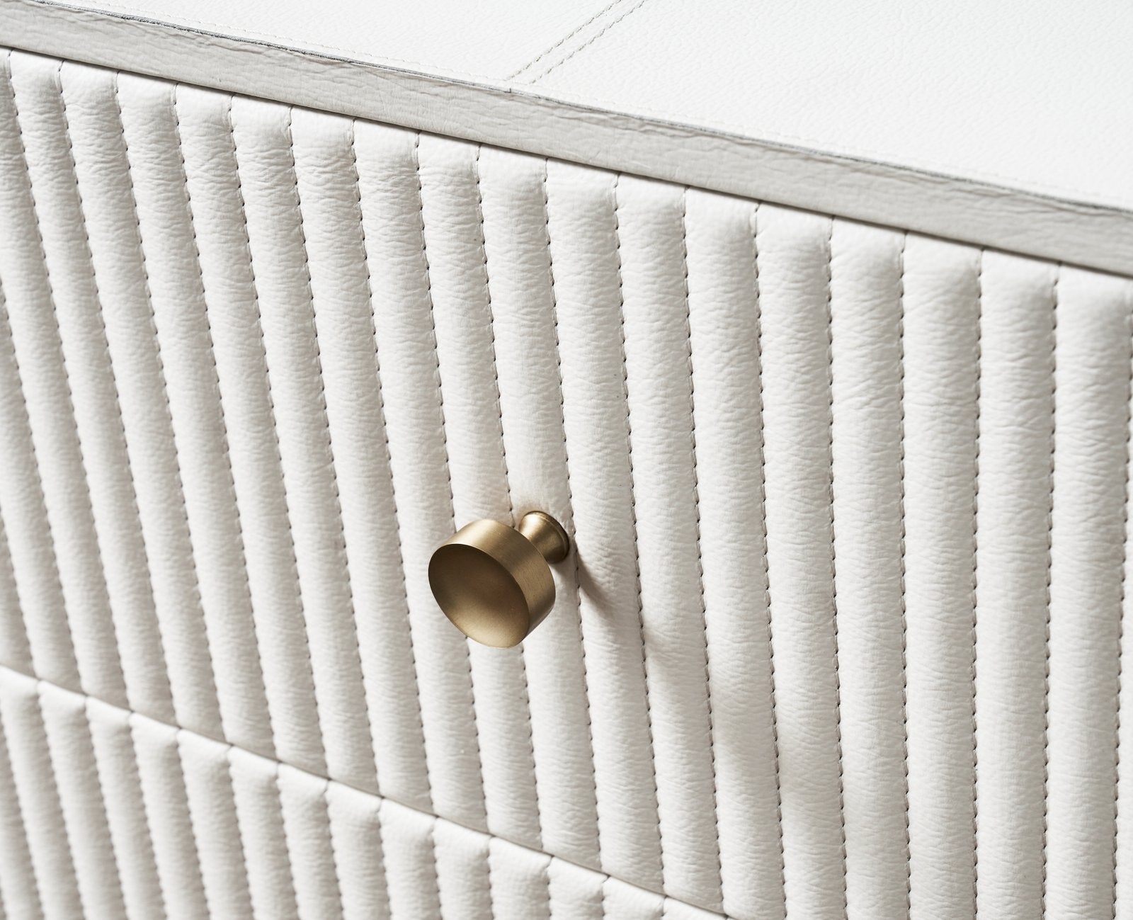 Stanford Fluted Two-Drawer Leather Nightstand white fluted leather brass knob close up drawer detail angled view