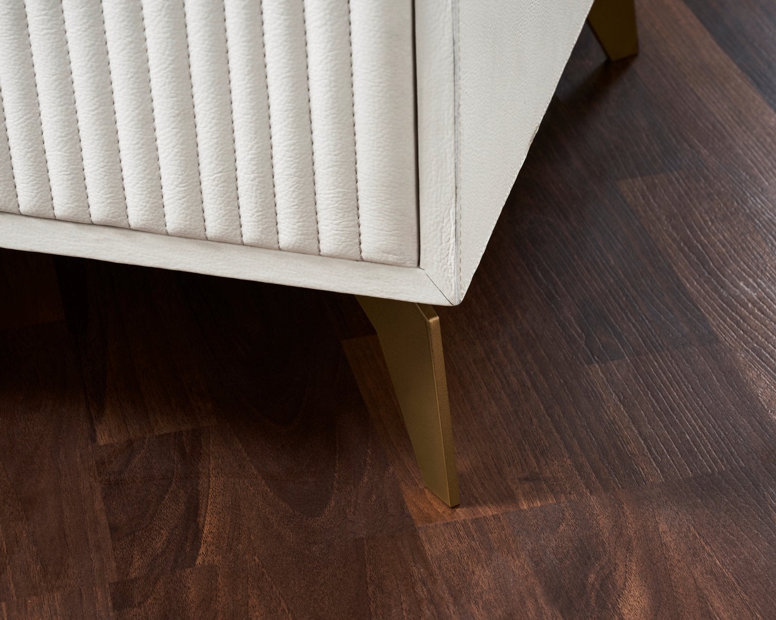 Stanford Fluted Two-Drawer Leather Nightstand white fluted leather detail brass legs close up dark hardwood floor