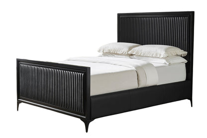 Black genuine leather quilted bed frame on white background showing full profile with vertical stripe quilting on panel headboard and footboard, matte black border, iron legs, styled with white bedding and pillows. 