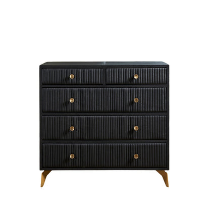 Stanford Ribbed Five-Drawer Leather Chest in black genuine leather front-facing view showing full ribbed drawer fronts and solid brass knobs on angled brass legs against white background