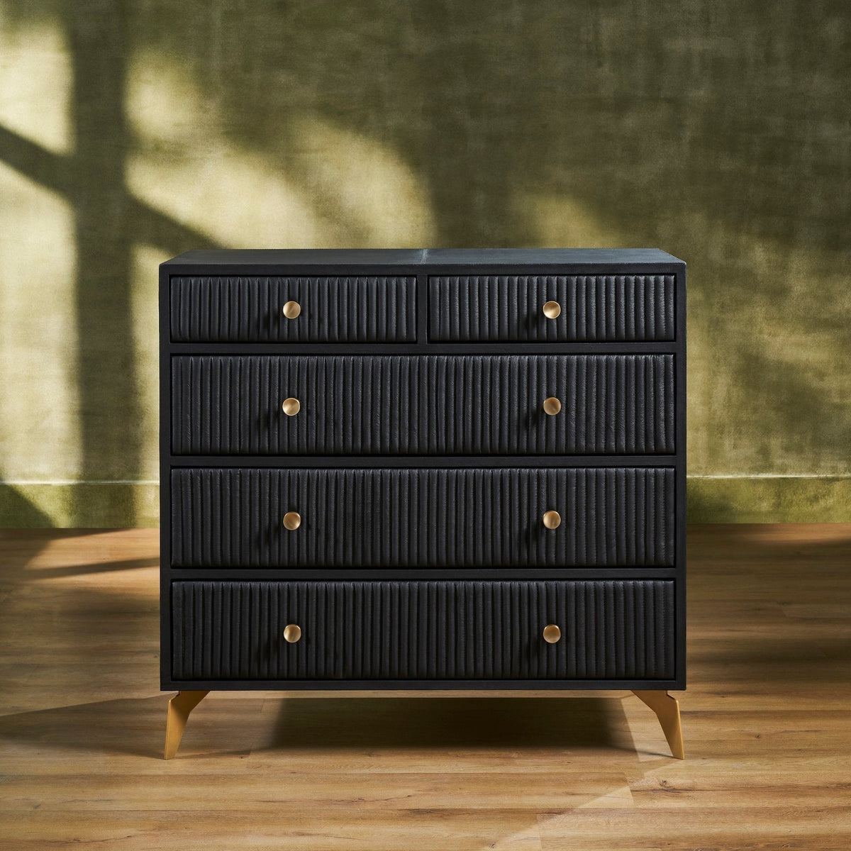 Stanford Ribbed Five-Drawer Leather Chest in black genuine leather with brass knobs and soft-close drawers on angled brass legs