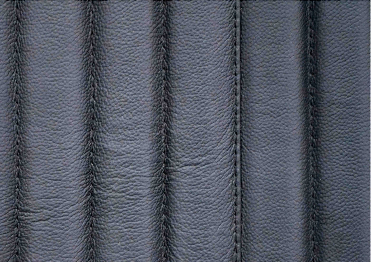 Close-up of vertical ribbed genuine leather surface with stitched seam detail on the Stanford black leather chest