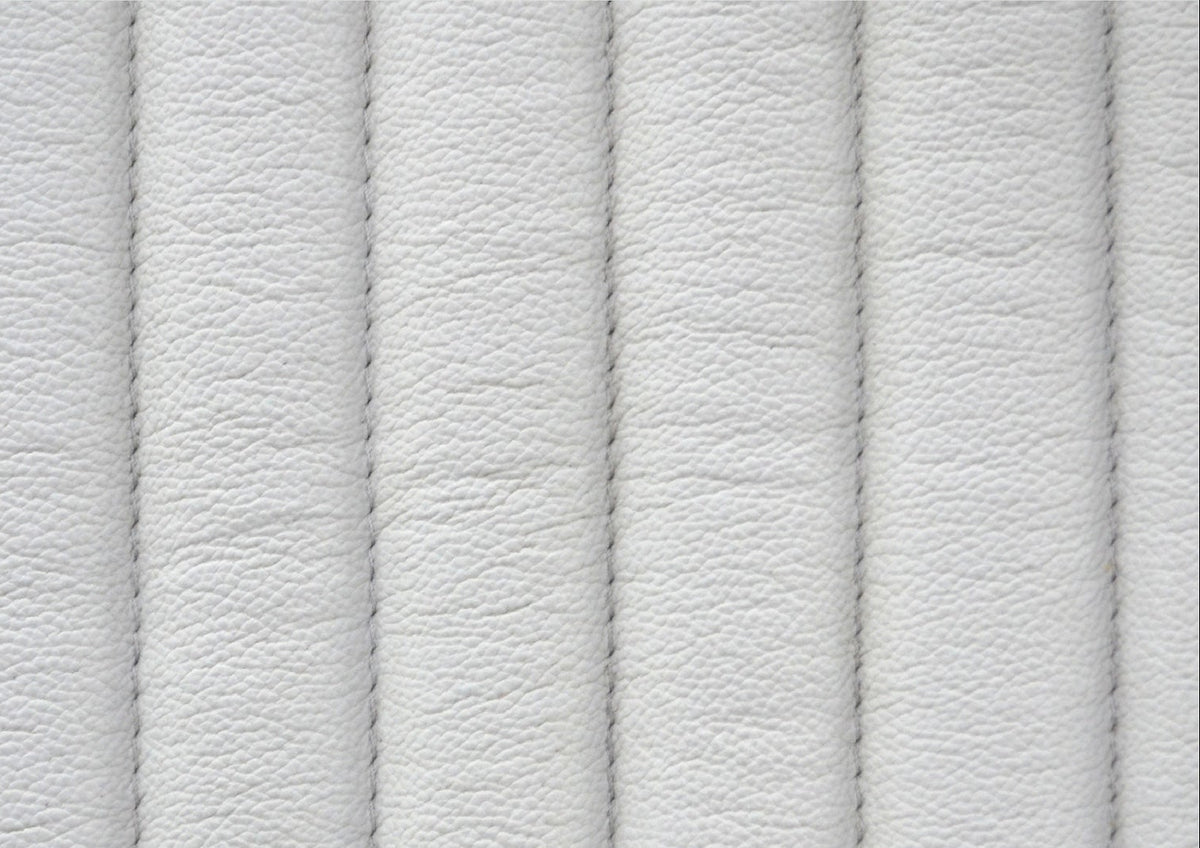 Close-up of vertical ribbed genuine leather surface with stitched seam detail on the Stanford white leather chest