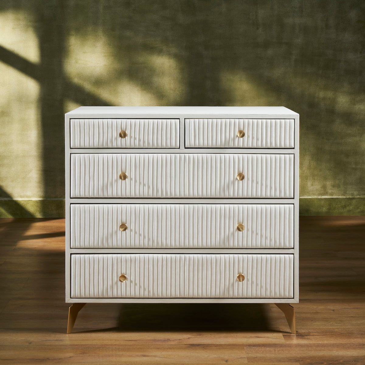 Stanford Ribbed Five-Drawer Leather Chest in white genuine leather with brass knobs and soft-close drawers on angled brass legs