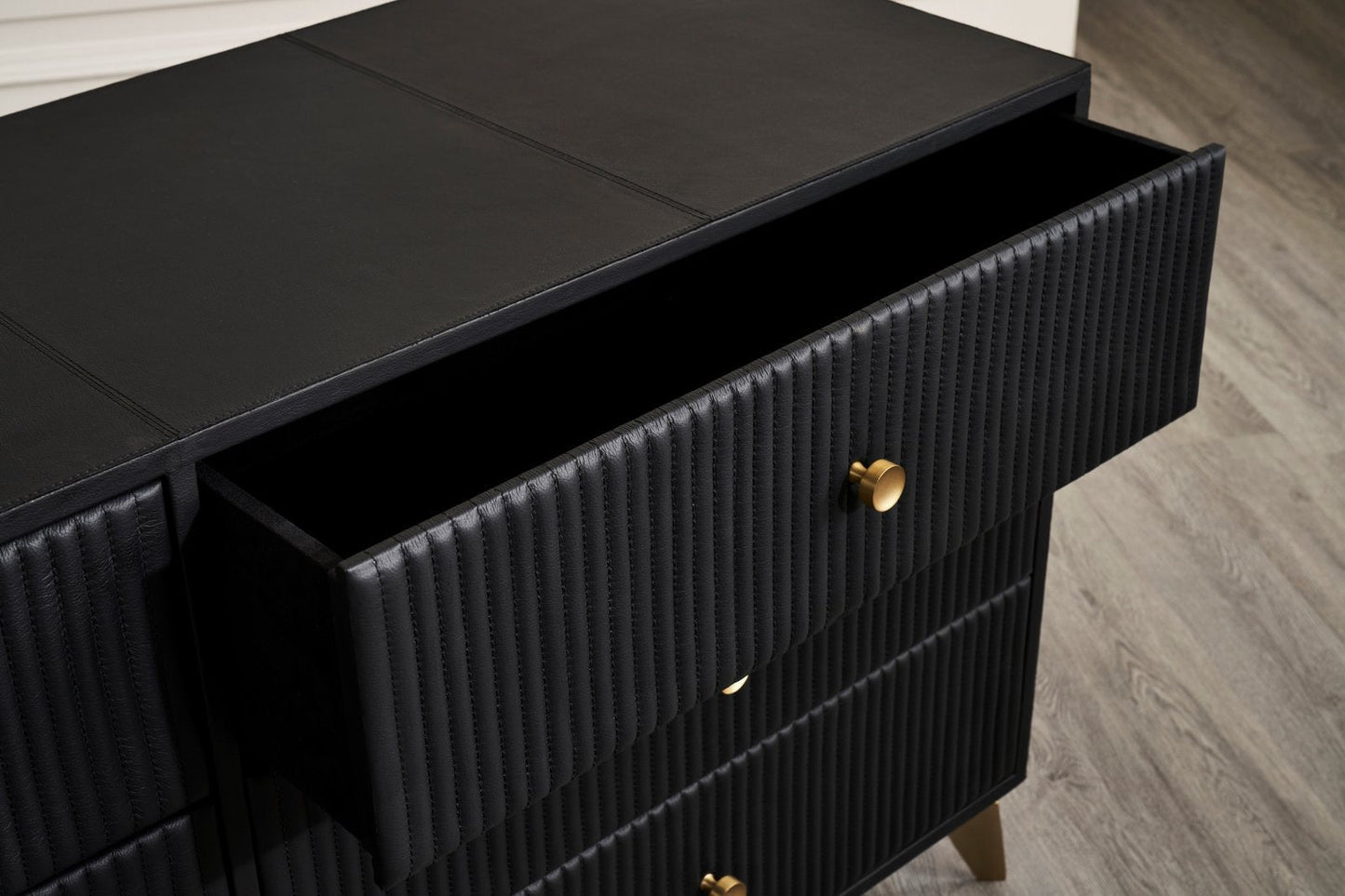 Stanford Ribbed Six-Drawer Leather Dresser black open drawer brass knob ribbed leather texture close-up detail hardwood floor