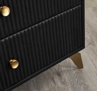 Stanford Ribbed Six-Drawer Leather Dresser black ribbed leather drawers brass knobs brass-finished tapered legs close-up hardwood floor
