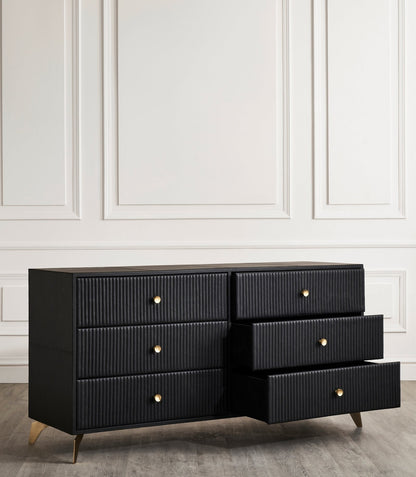 Stanford Ribbed Six-Drawer Leather Dresser black three drawers open brass knobs brass-finished legs white paneled wall
