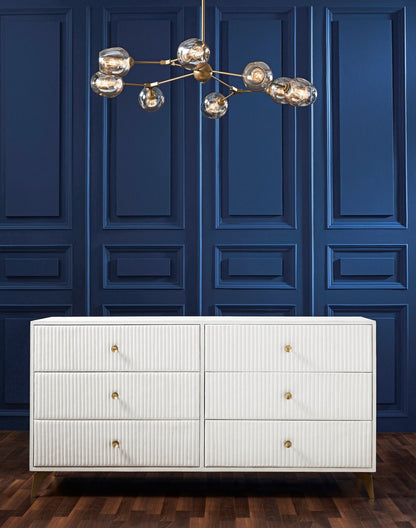 Stanford Ribbed Six-Drawer Leather Dresser white six drawers brass knobs brass-finished legs navy blue paneled wall brass globe chandelier hardwood floor