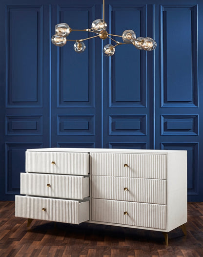 Stanford Ribbed Six-Drawer Leather Dresser white six drawers open brass knobs brass-finished legs navy blue paneled wall brass chandelier hardwood floor