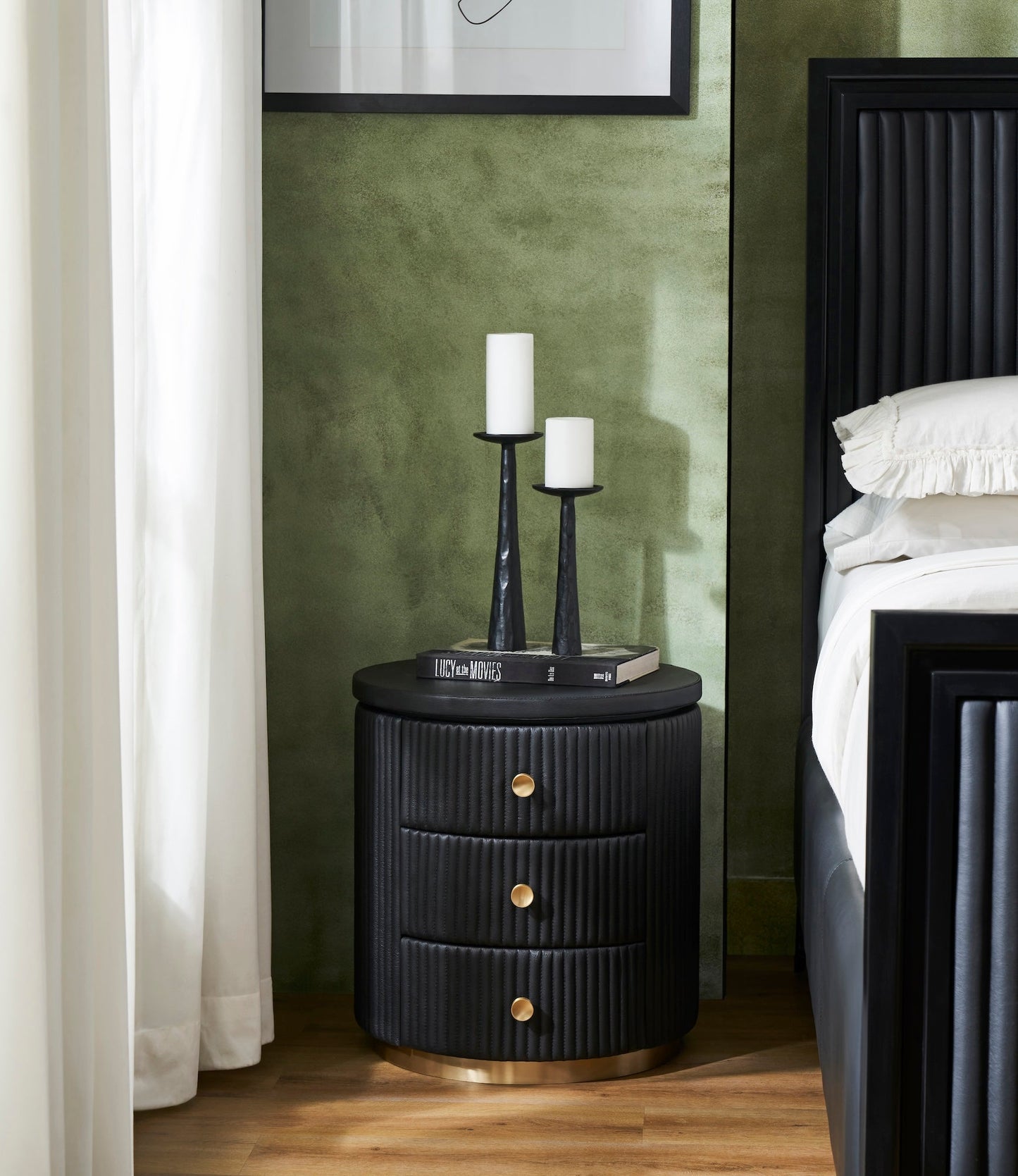 Stanford Round Fluted Leather Nightstand black candle holders books styled green bedroom beside fluted bed brass rim base side view