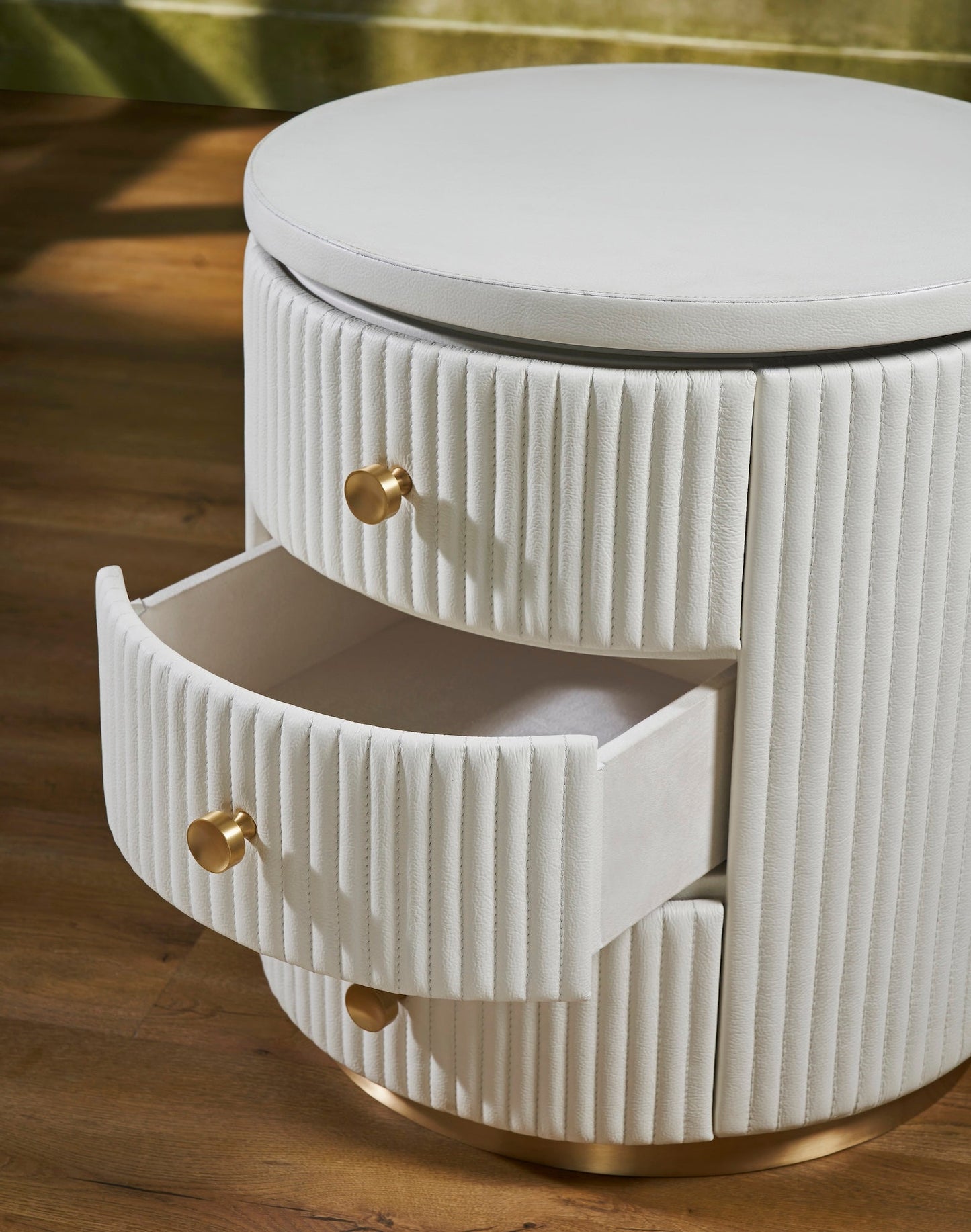 Stanford Round Fluted Leather Nightstand white drawer open fluted leather detail brass knobs brass rim base close up angled view