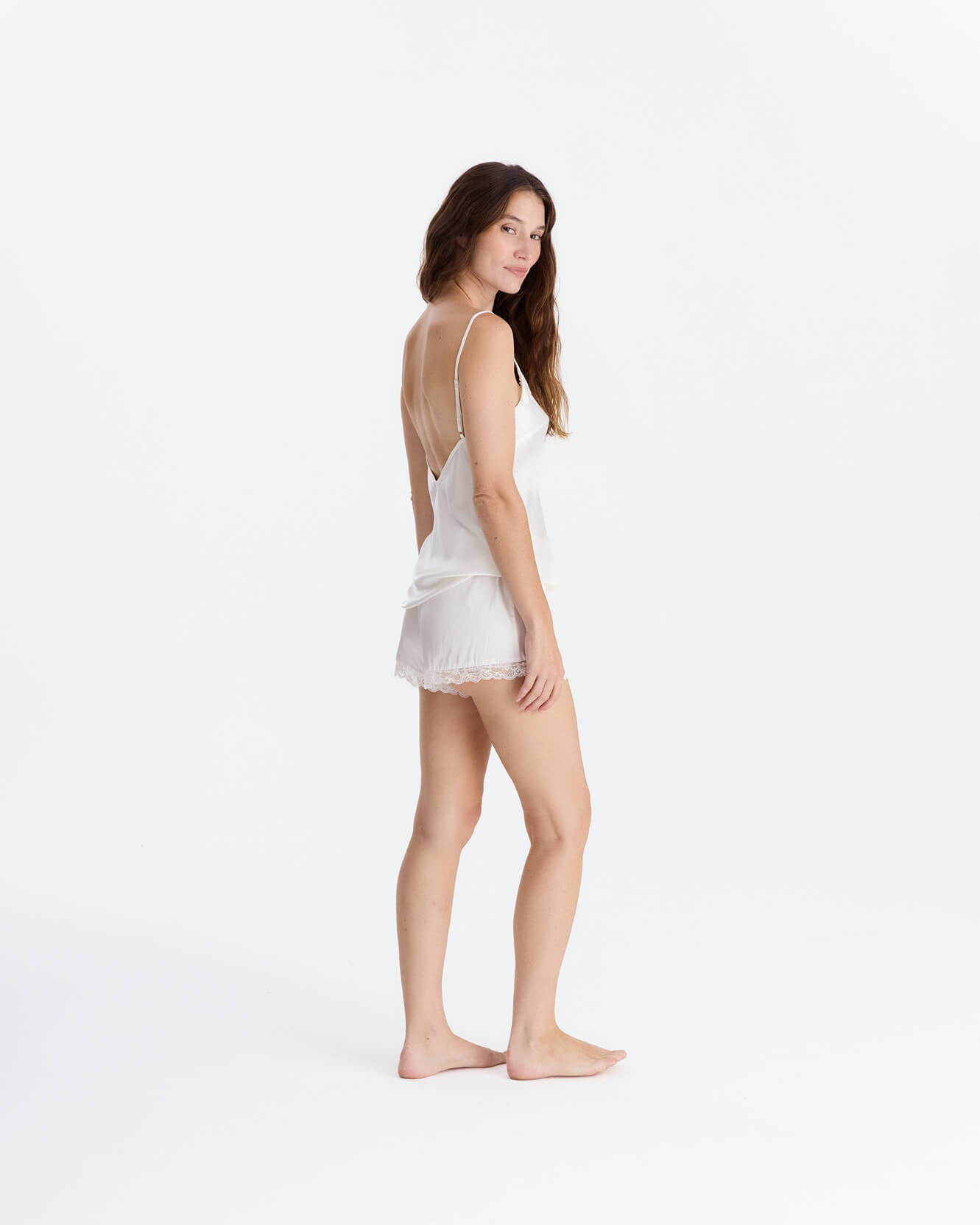 Off-white EcoSilk lace trim cami and short set on woman, three-quarter pose, front-facing view.
