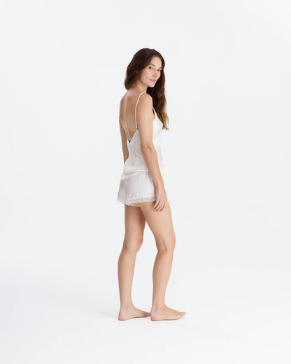 Off-white EcoSilk lace trim cami and short set on woman, three-quarter pose, front-facing view.
