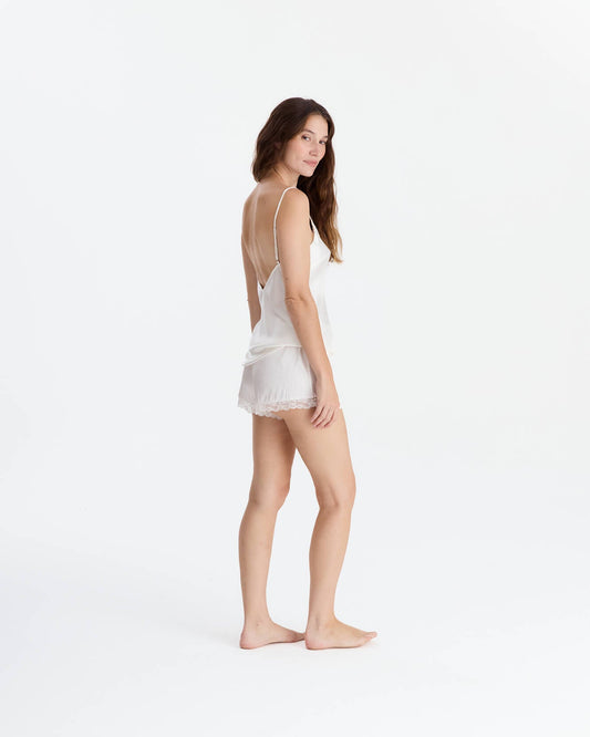 Off-white EcoSilk lace trim cami and short set on woman, three-quarter pose, front-facing view.
