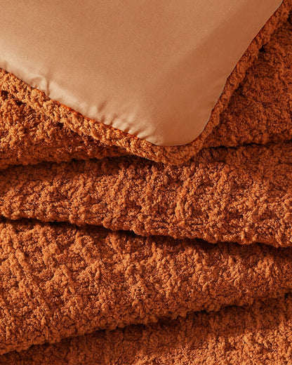 Close-up of Snug Waffle Comforter in Cinnamon Stick showing plush sherpa interior lining and waffle texture exterior detail