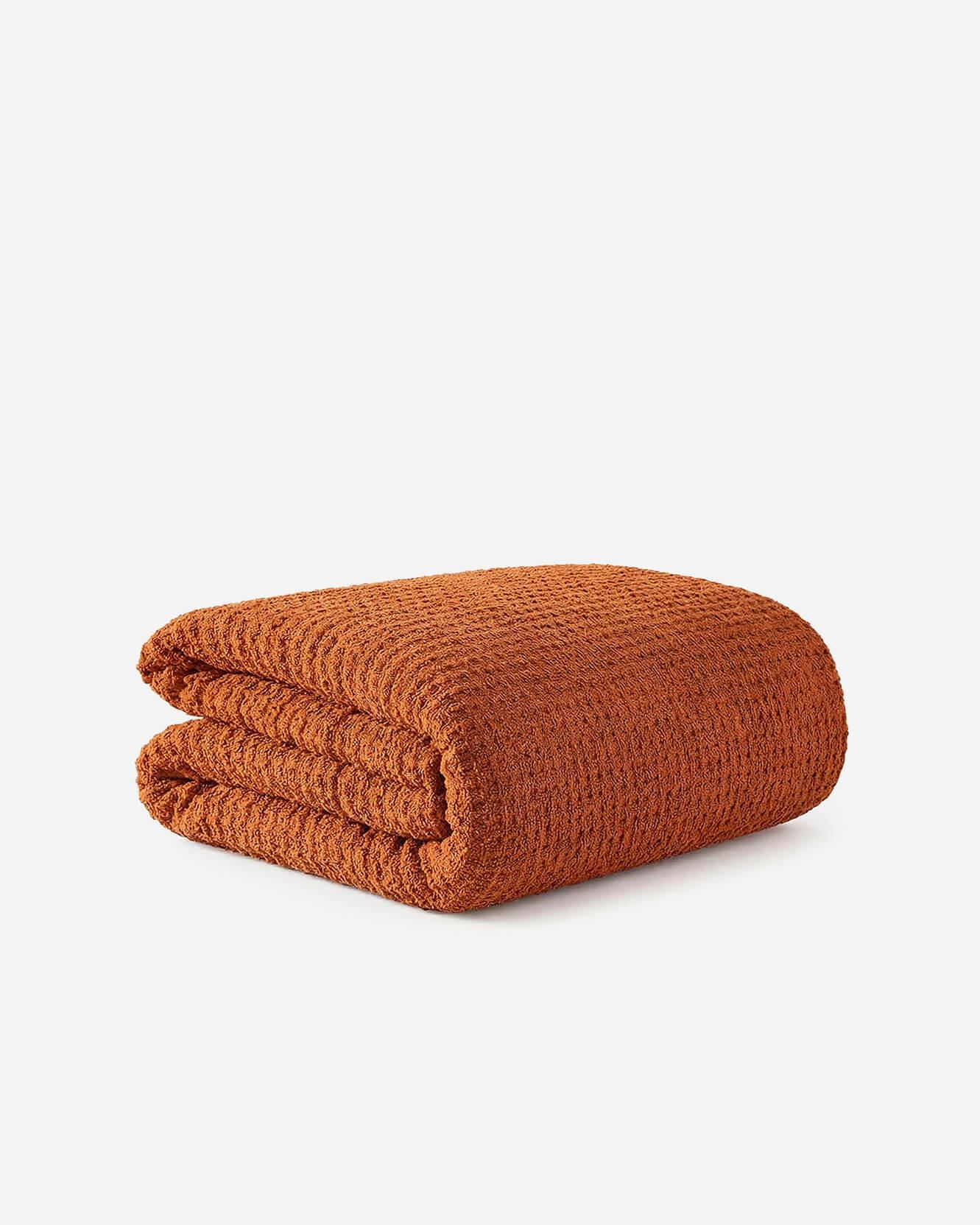 Cinnamon Stick Snug Waffle comforter folded neatly showing plush waffle texture and recycled fill construction on white background