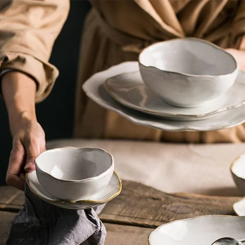 A premium Thetis Tableware Ceramic Set being styled for a meal, highlighting the vibrant glaze dinnerware and hand-thrown appeal of the artisanal round plates and bowls.