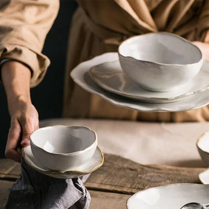 A premium Thetis Tableware Ceramic Set being styled for a meal, highlighting the vibrant glaze dinnerware and hand-thrown appeal of the artisanal round plates and bowls.