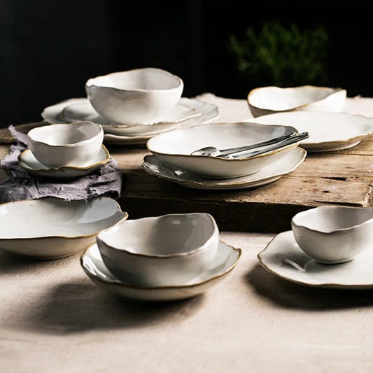 Thetis Tableware Ceramic Set displayed on a rustic wooden table featuring vibrant glaze dinnerware with hand-thrown appeal and organic round shapes for a premium dining experience.