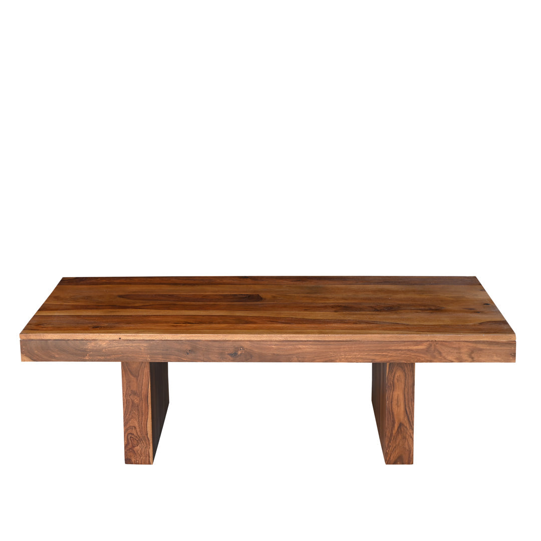 Solid seesham wood coffee table with thick flat top and chunky block legs shown against white background, natural grain variation visible across the surface