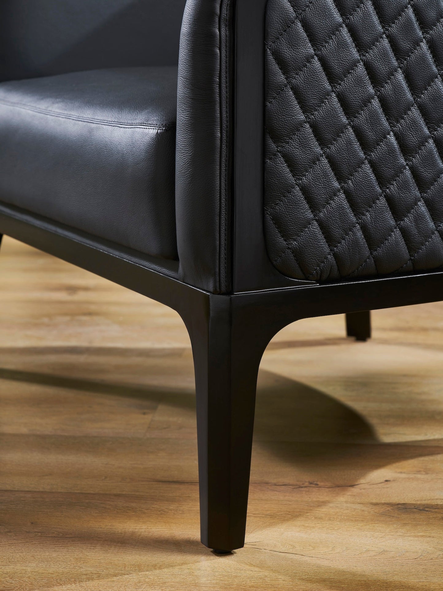Top-Grain Leather Lounge Chair black diamond quilting outer back detail hardwood legs hardwood floor