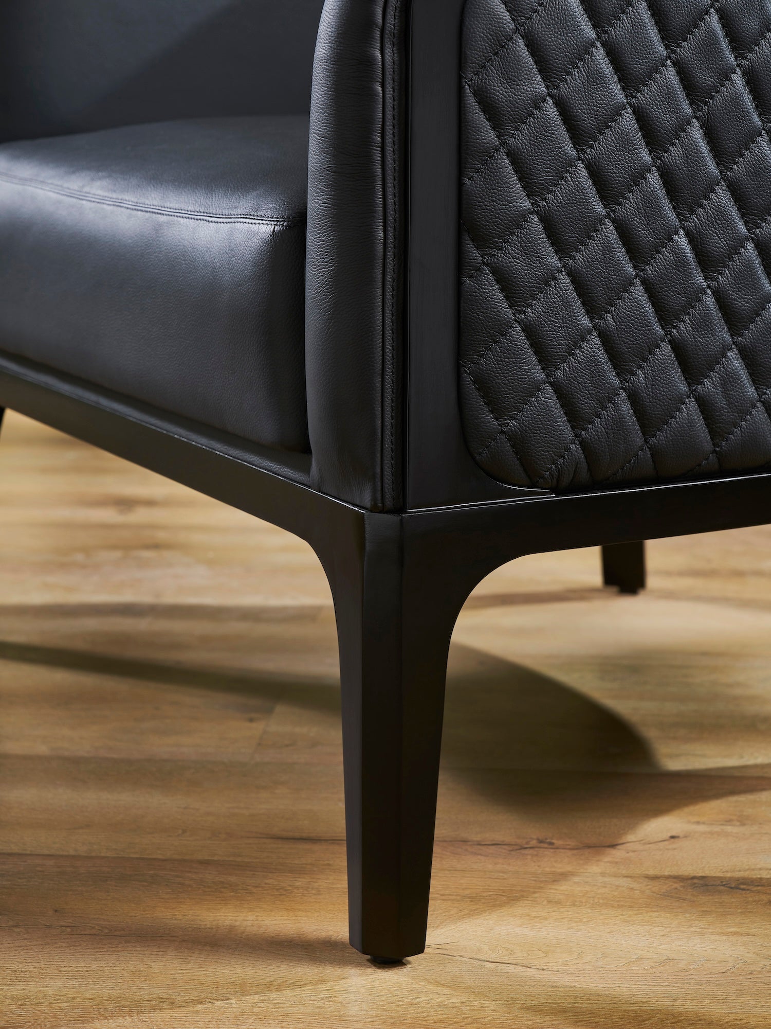 Top-Grain Leather Lounge Chair black diamond quilting outer back detail hardwood legs hardwood floor