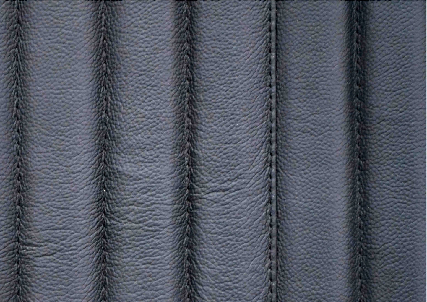 Top-grain leather lounge chair black genuine leather close texture natural grain detail 
