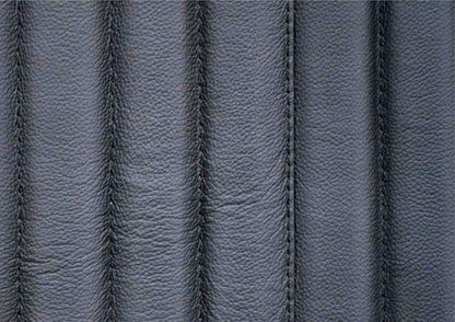 Top-grain leather lounge chair black genuine leather close texture natural grain detail 