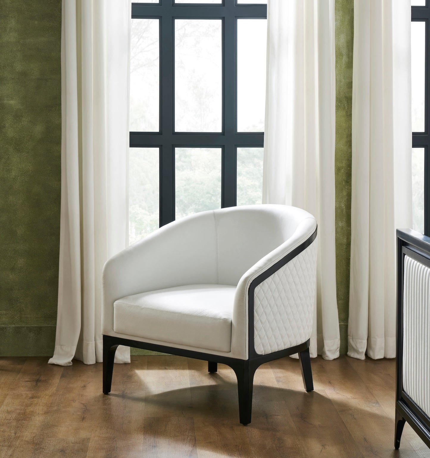 Top-Grain Leather Lounge Chair white curved form window natural light hardwood floor styled